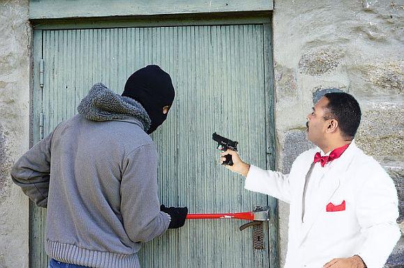 A thief catches another thief—the hooded one is trying to swipe the stolen loot the white-suited guy has behind the door A thief catches another thief—the hooded one is trying to swipe the stolen loot the white-suited guy has behind the door